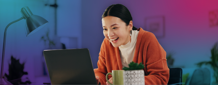 woman at her laptop happily surprised