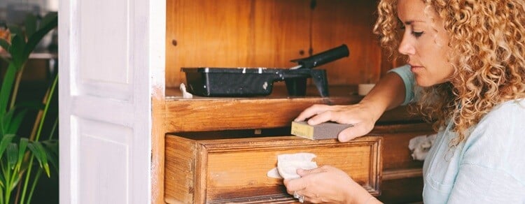 woman renovating a cabinet