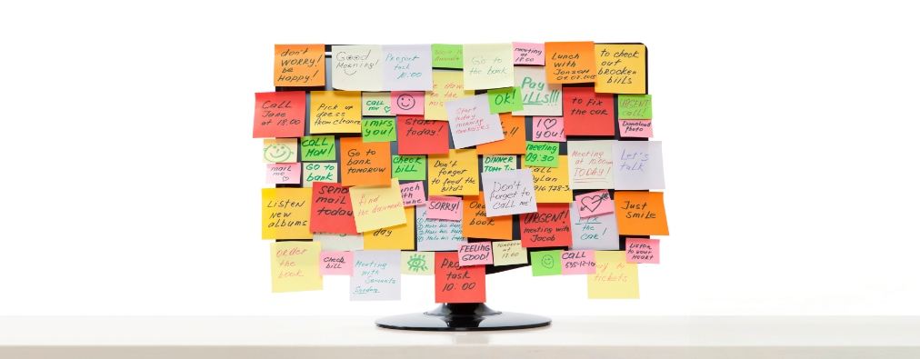 computer monitor covered with sticky notes